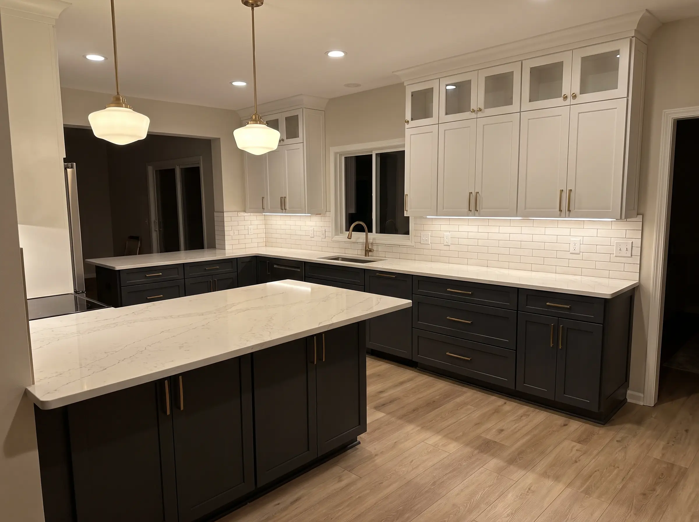 Remodeled kitchen with two-tone cabinets and quartz counters